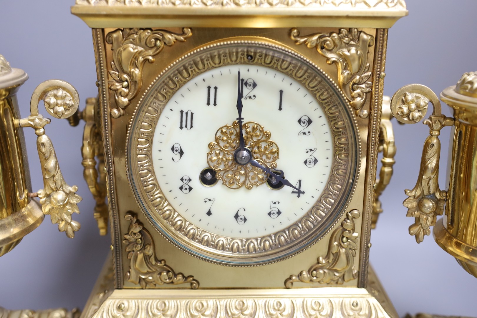 An early 20th century gilt brass three piece clock garniture 39cm